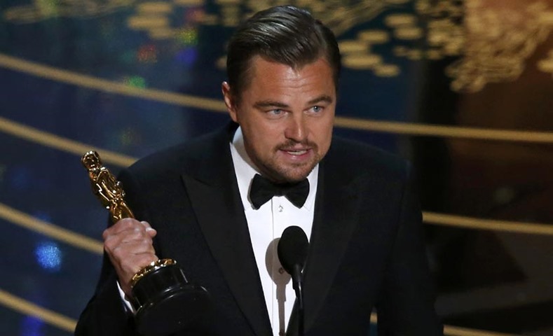 Leonardo DiCaprio holds the Oscar for Best Actor for \"The Revenant\"
