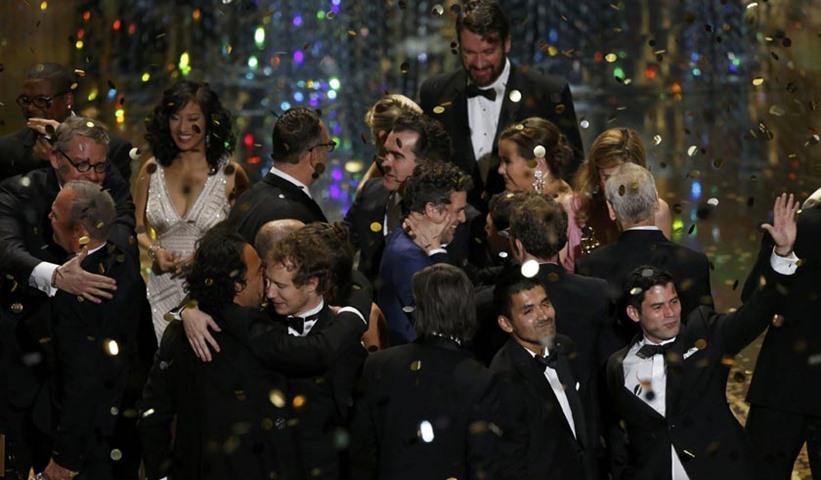 Oscar winners gather on stage after the end of the awards ceremony