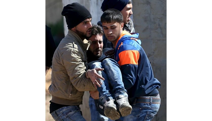 A wounded Palestinian is evacuated during clashes with Israeli troops in Qabatya