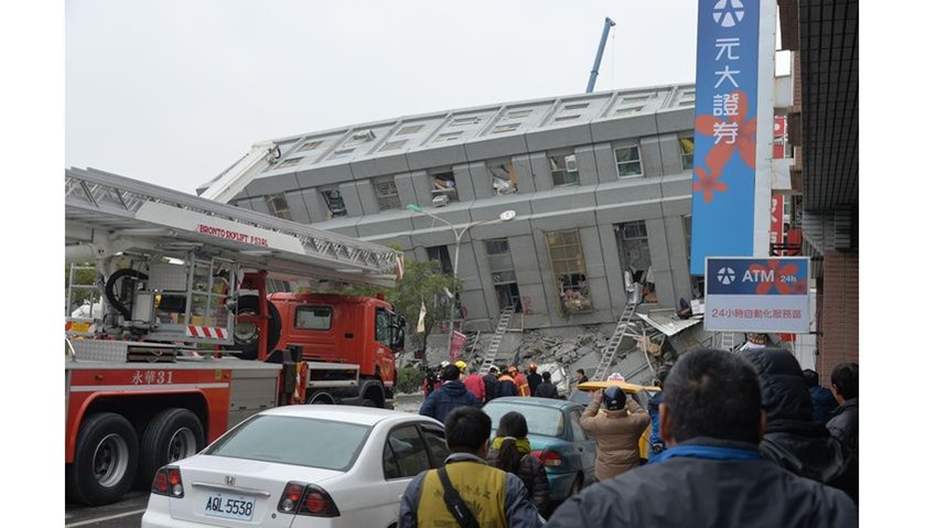 Rescue personnel search through debris at the site of a collapsed building in the southern Taiwanese