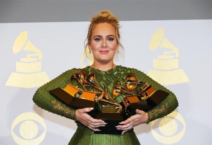 Adele holds her five Grammys during the 59th Annual Grammy Awards in Los Angeles