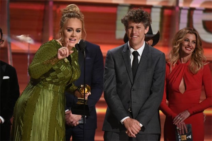 Adele addresses the crowd after receiving the Best record and Best album of the year awards