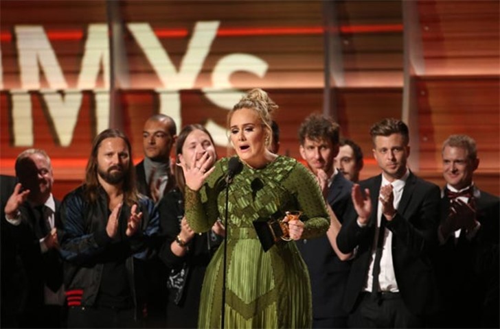 Adele accepts the Grammy for Record of the Year for ‘Hello’