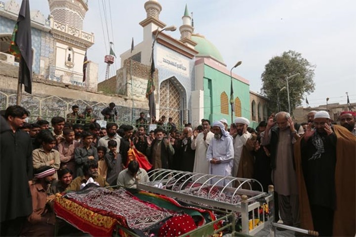 Relatives gather to attend funeral prayers for bombing victims in Sehwan Sharif in Sindh province