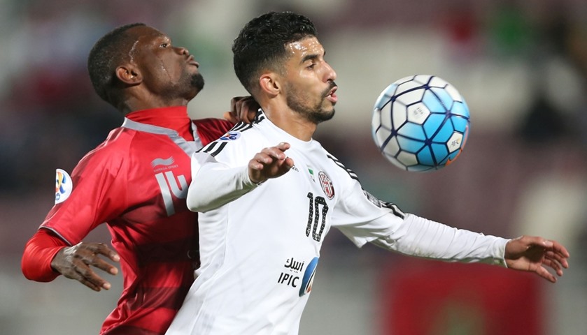 UAE Al-Jazira\'s Boussoufa Mbark (R) fights for the ball with Qatar Lekhwiya\'s Mohammed Tresor