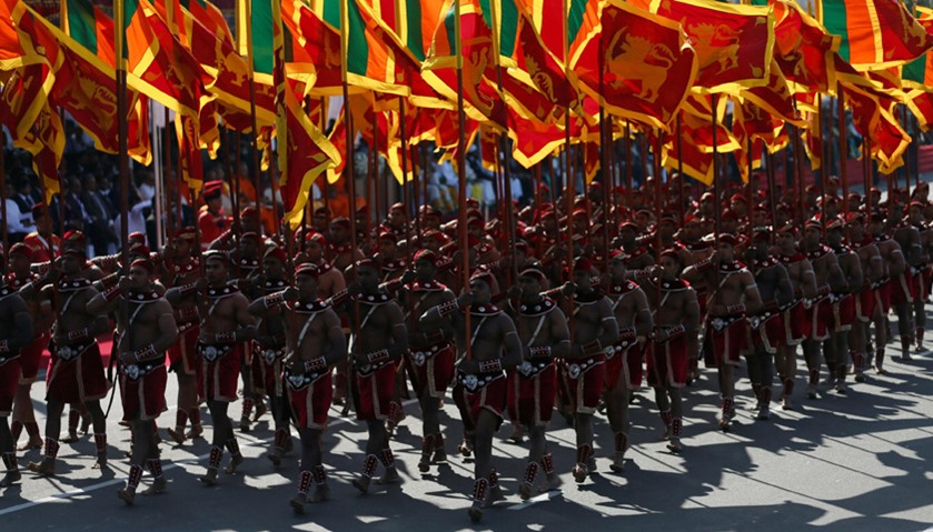 Members from the Sri Lankan military march with national flags during Sri Lanka\'s 69th Independence 