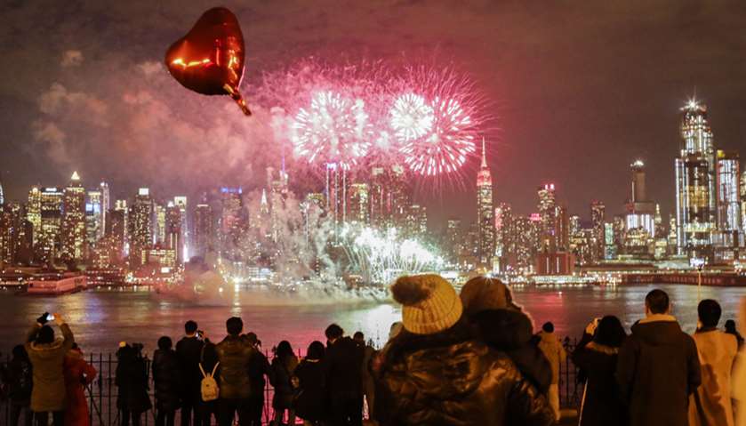 People watch fireworks explode over the Hudson River  marking Chinese New Year celebrations