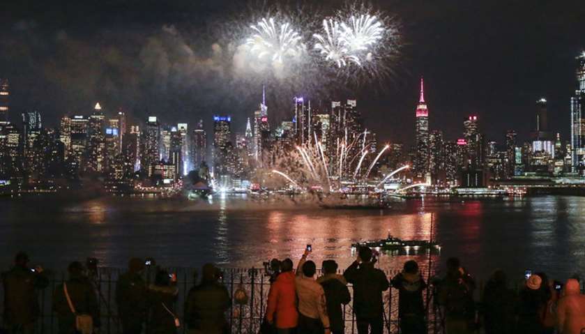 People watch fireworks explode against the backdrop of Manhattan marking Chinese New Year celebratio