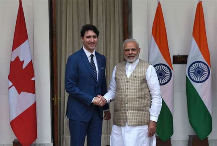 Justin Trudeau and Narendra Modi shake hands before a meeting in New Delhi on Friday
