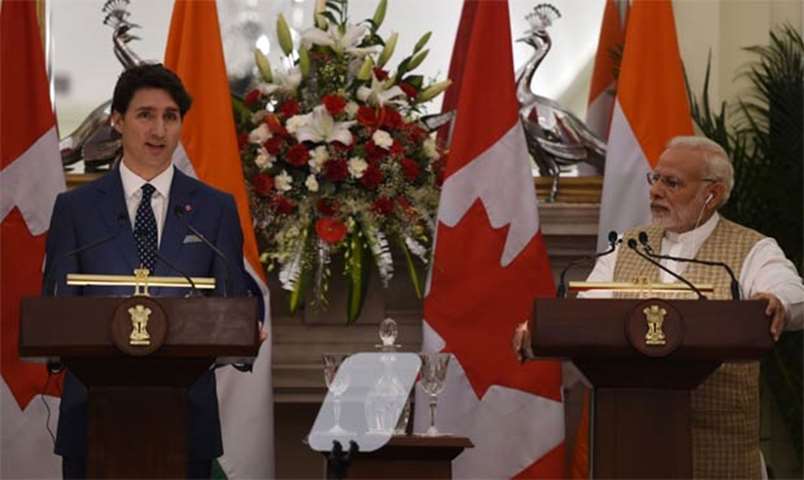 Narendra Modi watches Justin Trudeau speaking at a joint press conference in New Delhi