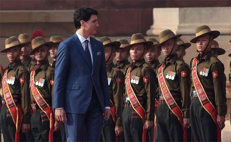 Justin Trudeau inspects a guard of honour at the Presidential Palace in New Delhi on Friday