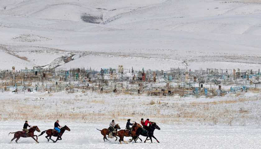 Mounted Kyrgyz riders play the traditional central Asian sport Kok-boru