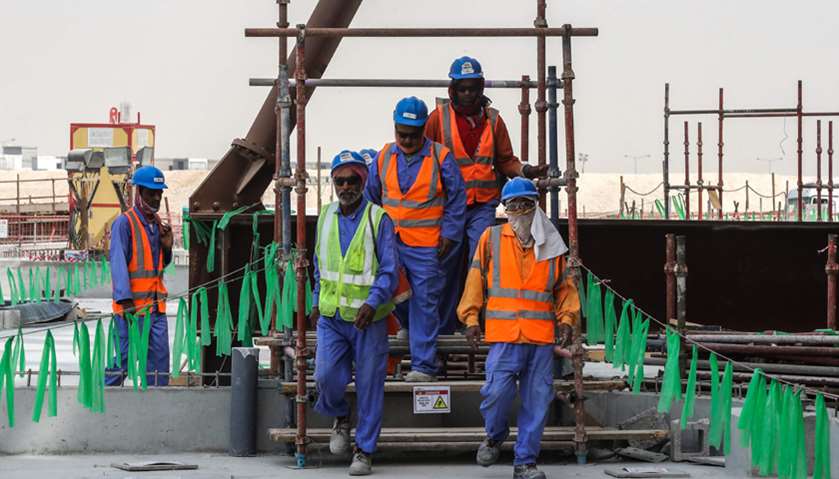 Workers posing on the construction site at Al-Wakrah Stadium, a World Cup venue