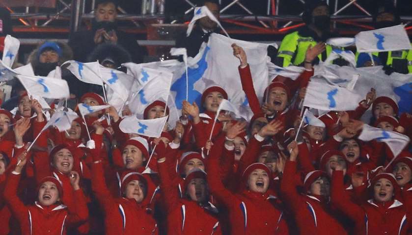 North Korea\'s supporters hold Korea\'s unification flag as they cheer