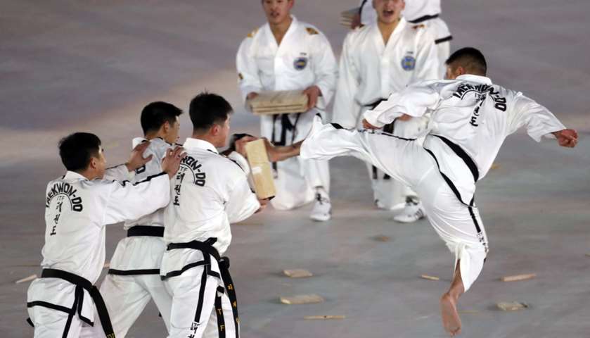 Martial artists perform before the start of the opening ceremony