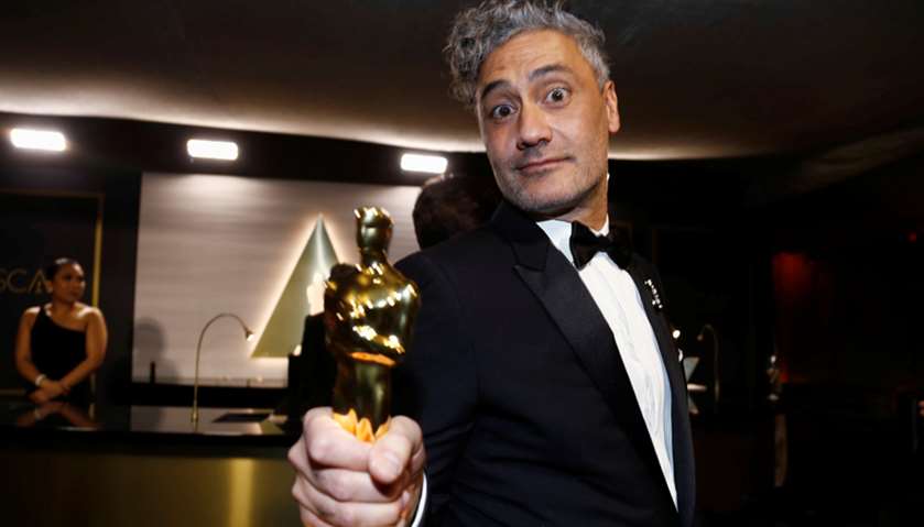 Taika Waititi poses with his Oscar for Best Adapted Screenplay for \"Jojo Rabbit\" at the Governors Ba