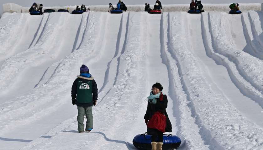 People take part in snow rafting