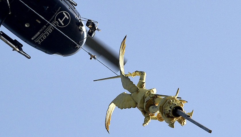 Helicopter lifts the statue of Archangel Michael from top of Mont Saint-Michel Abbey for maintenance