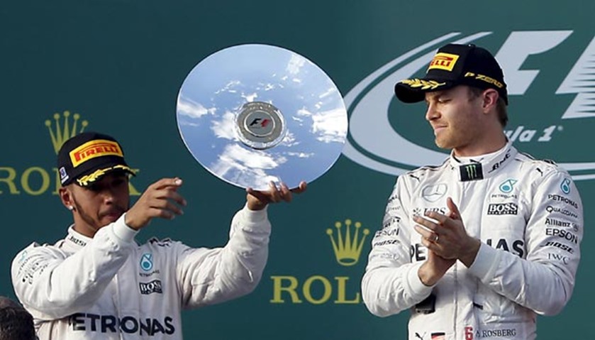 Mercedes F1 driver Lewis Hamilton (L) celebrates as teammate Nico Rosberg wins the Grand Prix