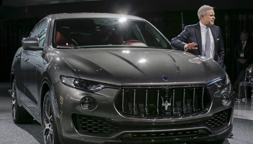 Maserati CEO Harald Wester stands beside the Maserati Levante SUV during a media preview