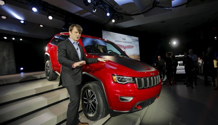 Michael Manley, CEO of Chrysler Group\'s Jeep brand, poses next to the Jeep Cherokee Trailhawk SUV