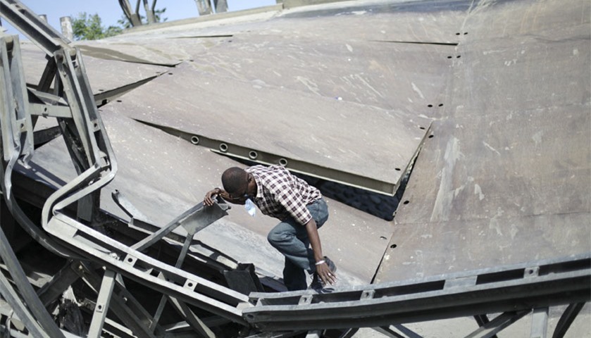 A man crosses the collapsed bridge