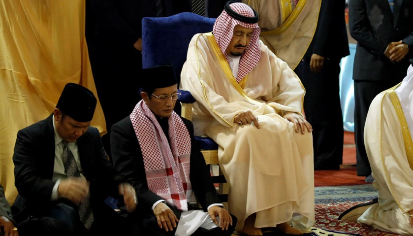King Salman of Saudi Arabia sits as he prays at the Istiqlal Mosque in Jakarta, Indonesia