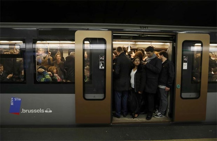 People observe a minute of silence in a subway car at a train station in Brussels