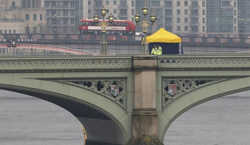 Police officers and forensics investigators work on Westminster Bridge