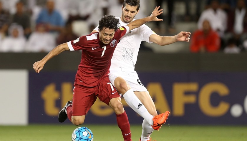 Qatar\'s midfielder Rodrigo Tabata (L) vies for the ball against Iran\'s midfielder Saied Ezatolahi