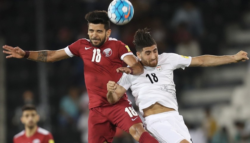 Qatar\'s midfielder Luiz Junior (L) vies for the ball against Iran\'s forward Alireza Jahan Bakhsh