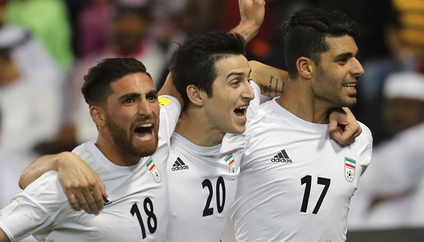 Iran\'s Mehdi Taremi (R) celebrates with his teammates Sardar Azmoun (C) and Alireza Jahan Bakhsh aft