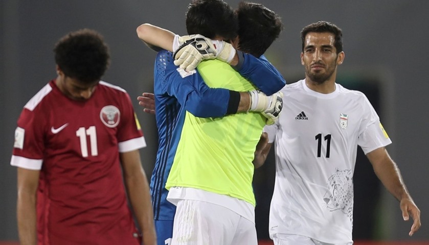 Qatar\'s Akram Hassan Afif (front) reacts as Iran\'s players celebrate 

