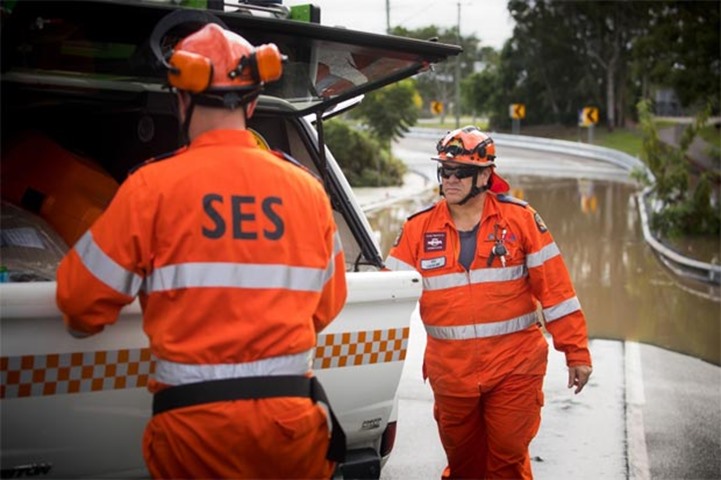 A State Emergency Service crew inspects a flooded road in Beenleigh in Queensland state