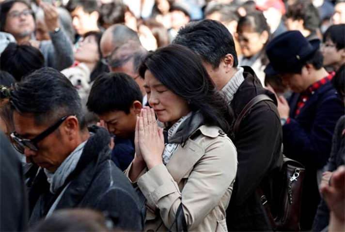 People in Tokyo observe silence at 2:46 pm, the time when an earthquake struck in 2011