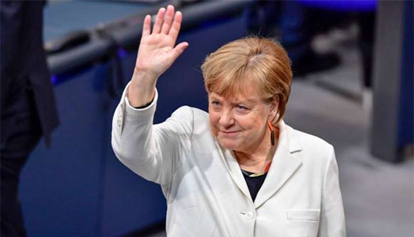 Angela Merkel waves as she arrives to attend the parliament session for the chancellor\'s election