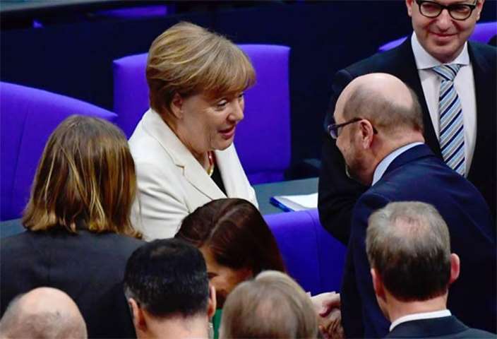 German Chancellor Angela Merkel is congratulated by Martin Schulz, former leader of the SPD party