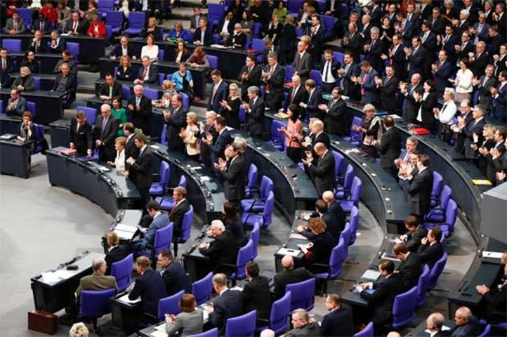 Parliament members give a standing ovation after German Chancellor Angela Merkel was re-elected