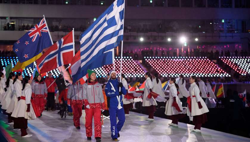 Konstantinos Petrakis GRE carries the national flag of Greece as he leads the athletes in the stadiu