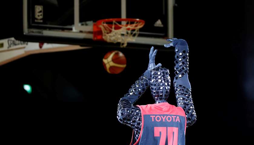 A basketball-playing robot called CUE, developed by Toyota engineers, shoots a free throw