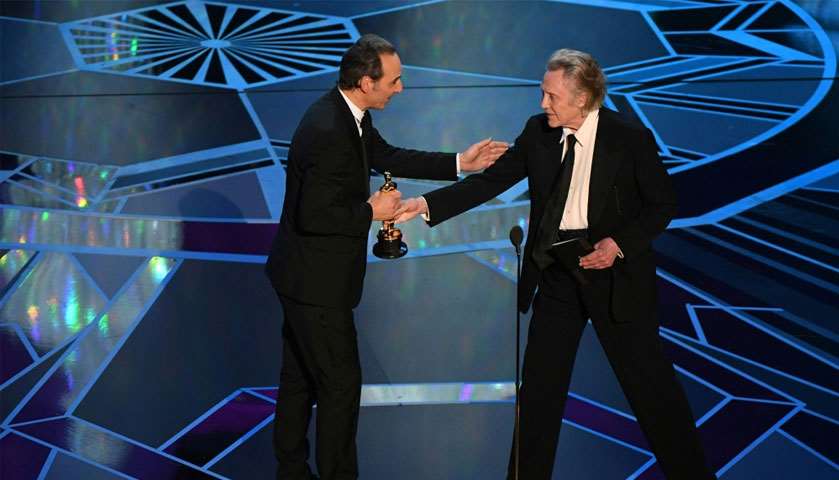 Composer Alexandre Desplat (L) accepts the Oscar for Best Original Score for \"The Shape of Water\"