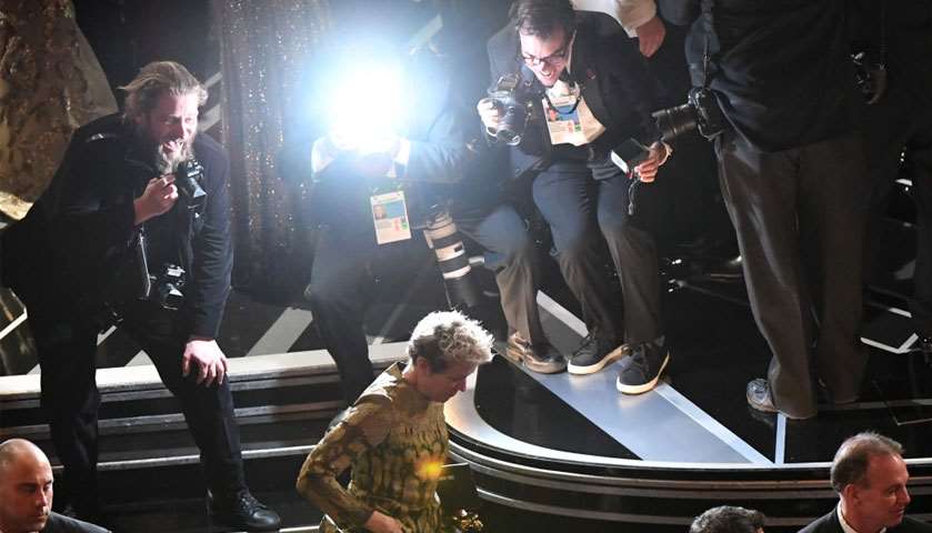 Frances McDormand (C) leaves the stage after she won the Oscar for Best Actress