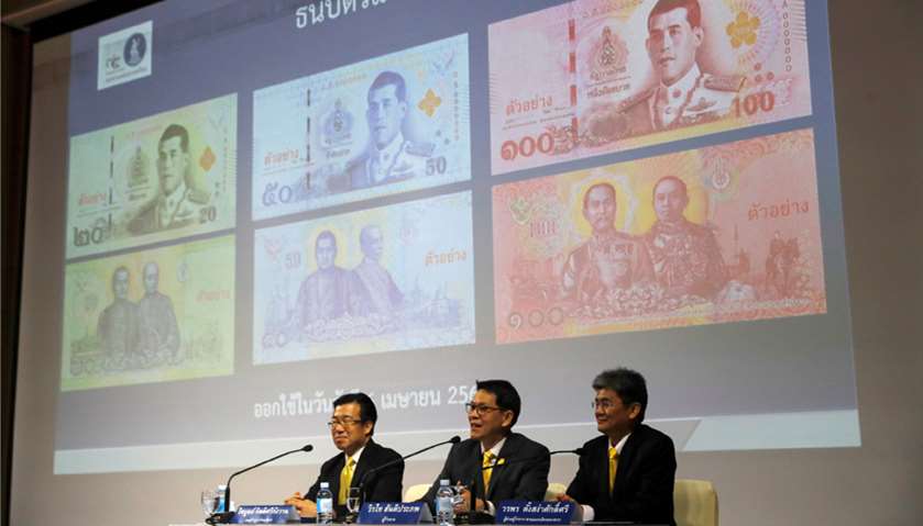 Central bank governor Veerathai Santiprabhob unveils new baht bank notes featuring Thailand\'s King M