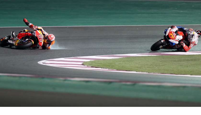 Repsol rider and current world champion Marc Marquez of Spain (L) crashes