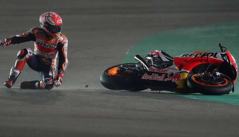 Repsol rider and current world champion Marc Marquez of Spain tries to get up after crashing