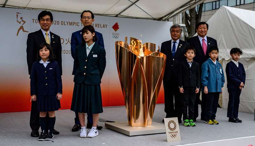 The Tokyo 2020 Olympic flame is displayed outside Fukushima railway station