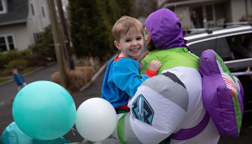 Kellen Shea, watches as a caravan of cars rides past to wish him  happy third birthday