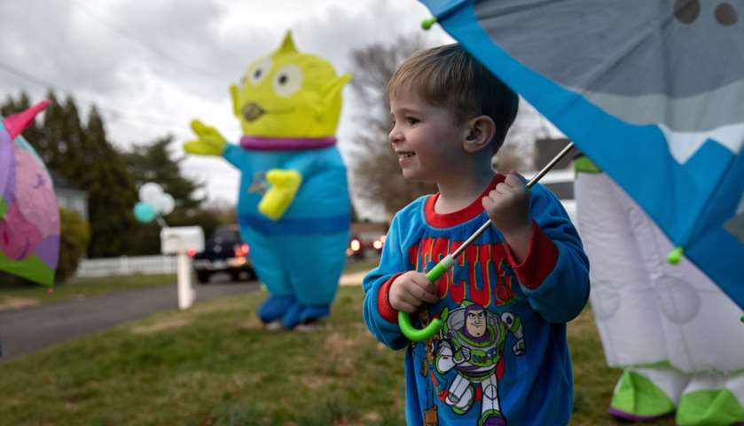 Kellen Shea, watches as a caravan of cars rides past to wish him  happy third birthday
