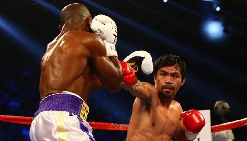 Manny Pacquiao moves in with a punch against Timothy Bradley