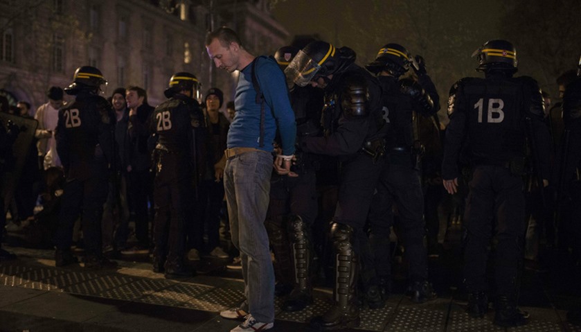 French gendarme arrest a man at the Place de la République following violent protests
